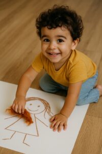 צעד לקראת הליבוד-ילד קטן מדביק צמר גולמי לציורו